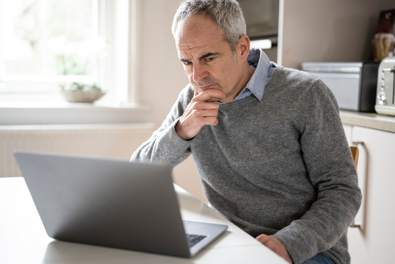 A man looking at his laptop