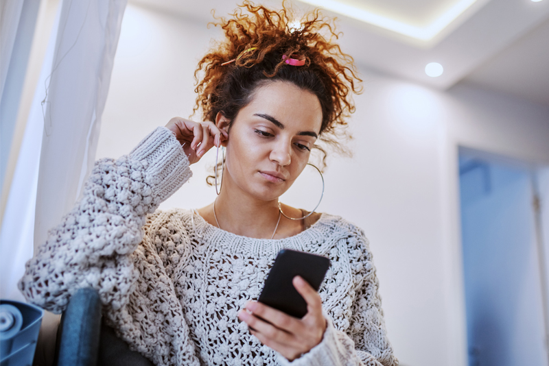 A woman looking at her mobile device